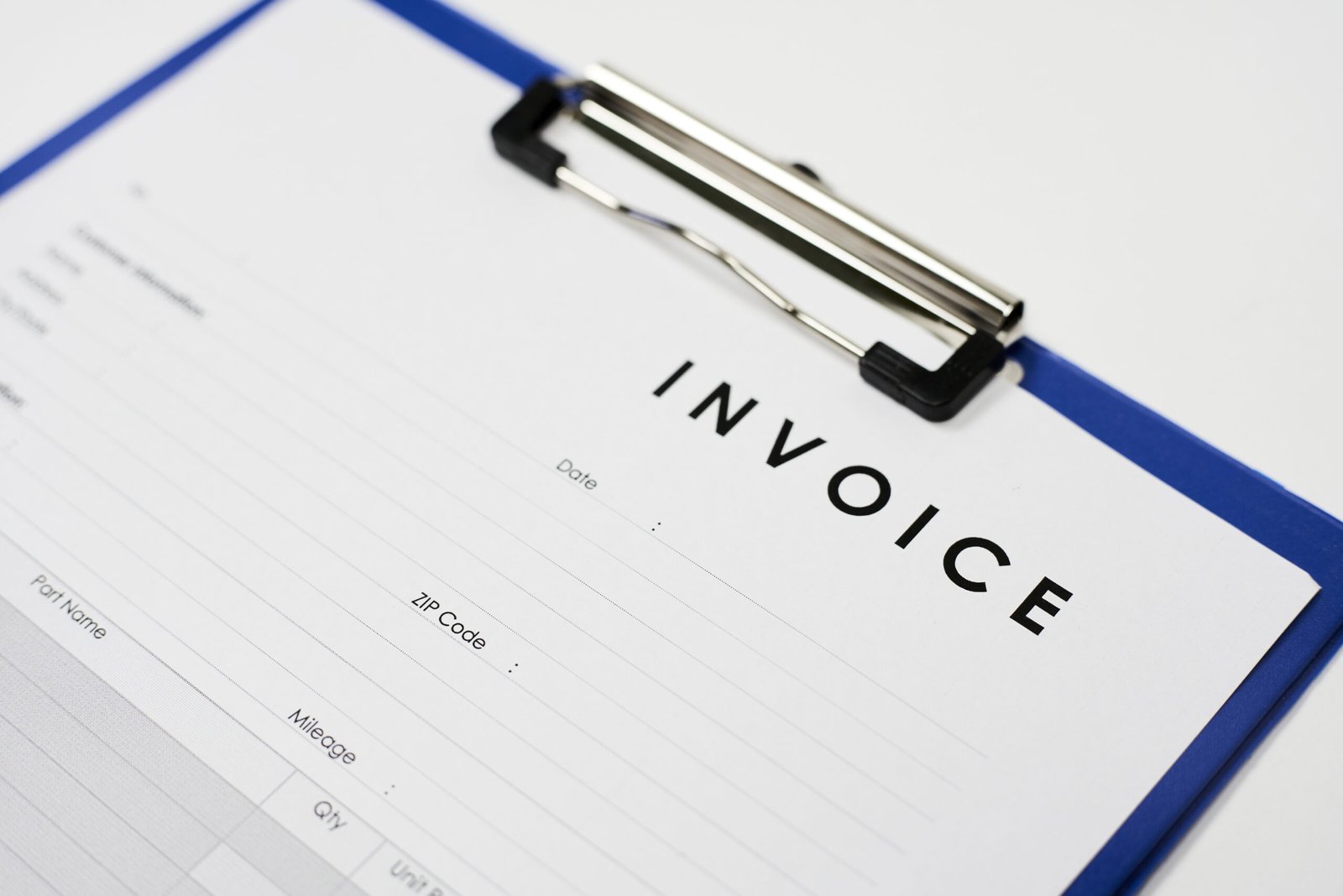 A closeup shot of an invoice document on a white surface